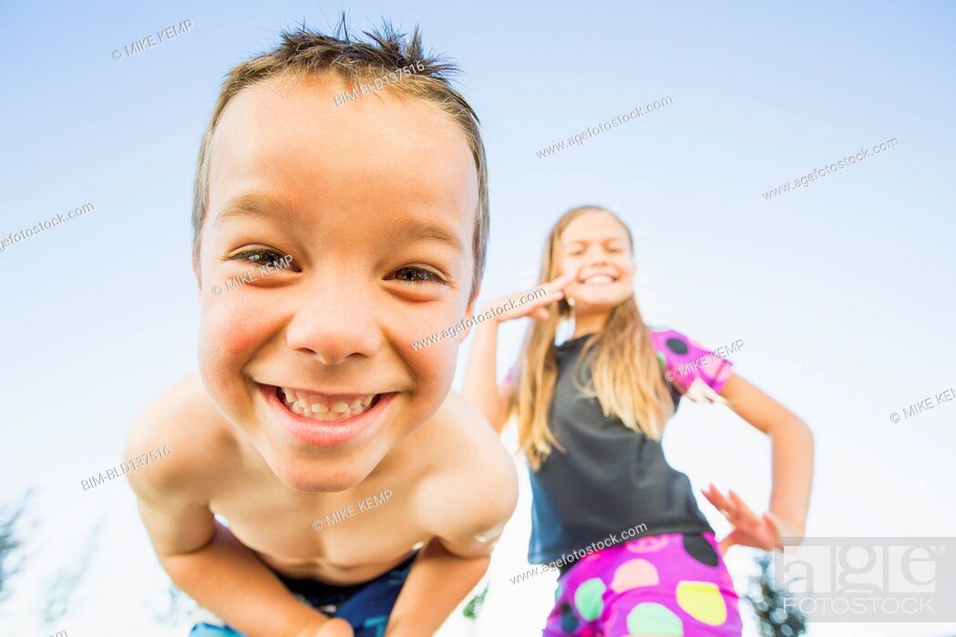 Stock Photo: Low angle view of Caucasian children smiling outdoors.