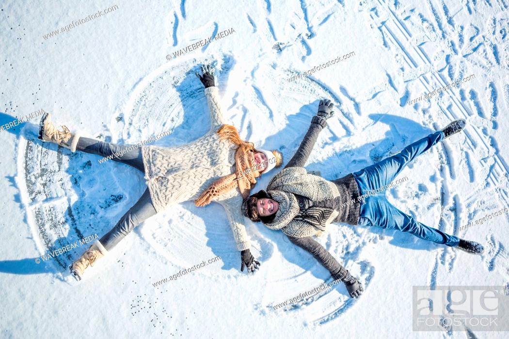 Stock Photo: Couple doing snow angel.