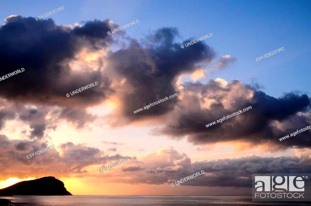 Stock Photo: Cloudscape, Colored Clouds at Sunset near the Ocean.