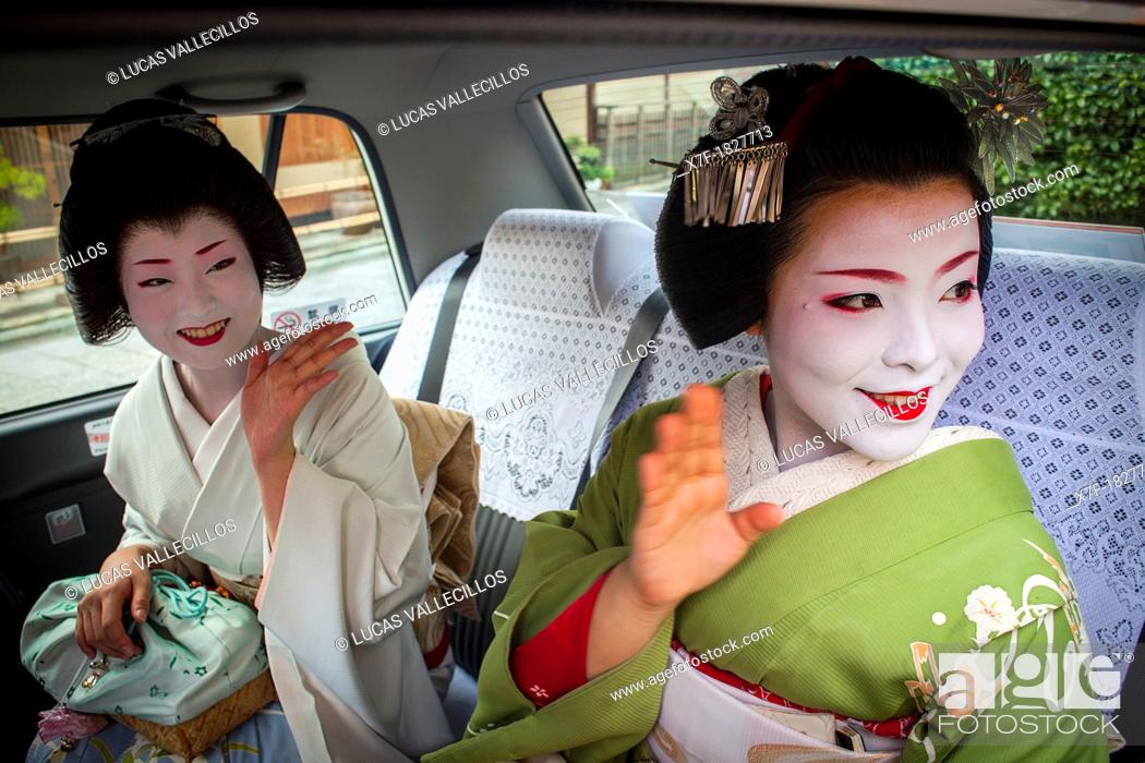 Stock Photo: Fukuyu, geisha and Fukukimi, 'maiko' geisha apprenticein taxi going to work They say goodbye at Oka san  Geisha's distric of Miyagawacho Kyoto  Kansai, Japan.