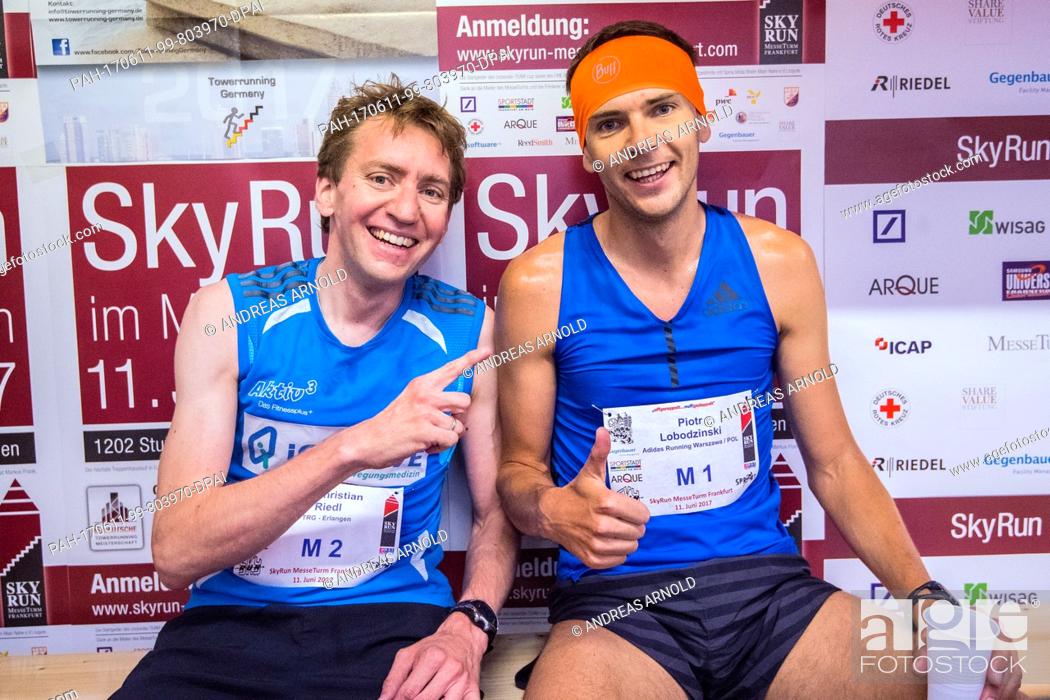 Stock Photo: Christian Riedl (L) of TRG Erlangen and Piotr Lobodzinski from Poland sit together after finishing the race alongside each other in Frankfurt am Main, Germany.