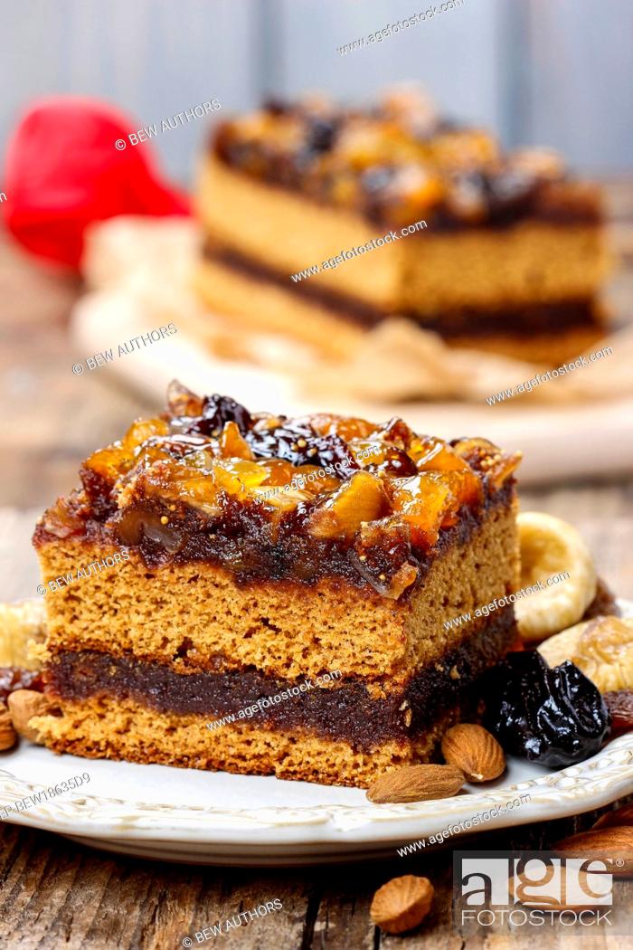 Stock Photo: Delicious layer gingerbread cake decorated with dried fruits.