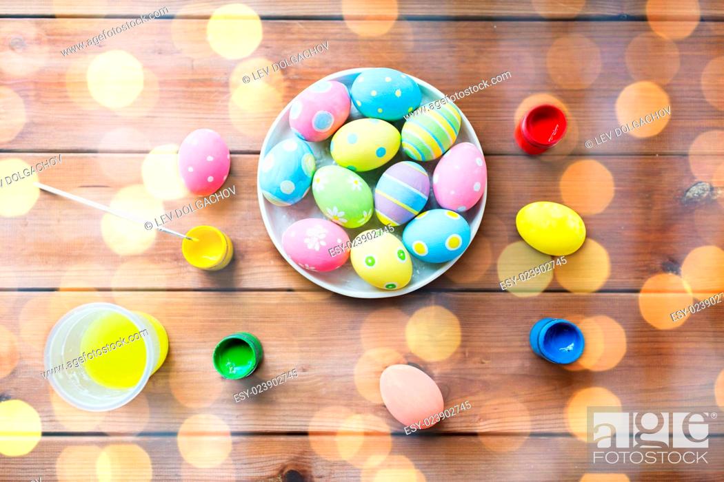 Stock Photo: easter, holidays, tradition and object concept - close up of colored easter eggs on plate.