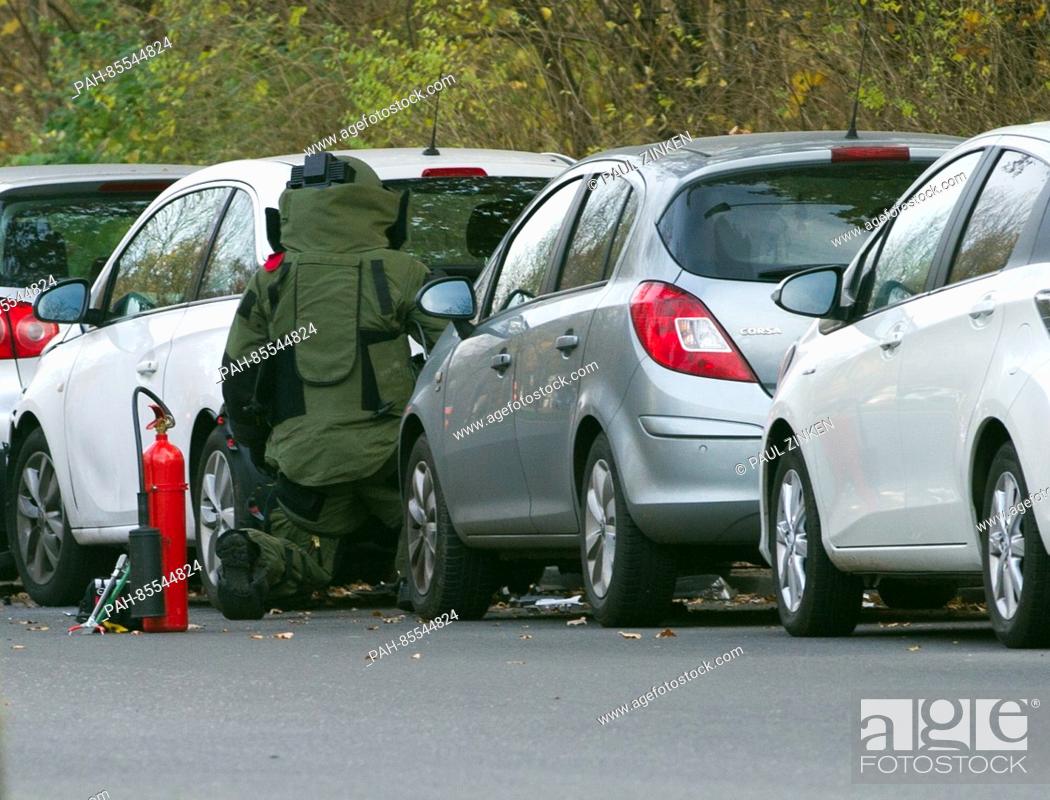 Stock Photo: An explosives expert from the police inspects a car in the borough of Neukoelln in Berlin, Germany, 10 November 2016. A loud bang was heard coming from the car.