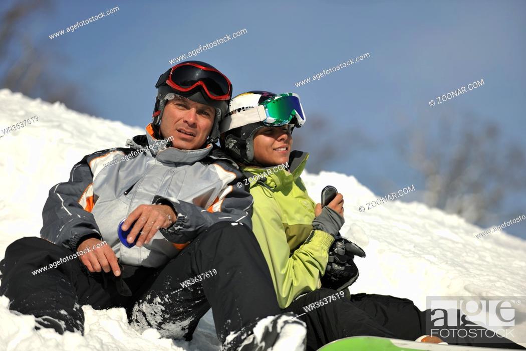 Stock Photo: young snowboarders couple relaxing and enjoy on sunny winter day on fresh snow.