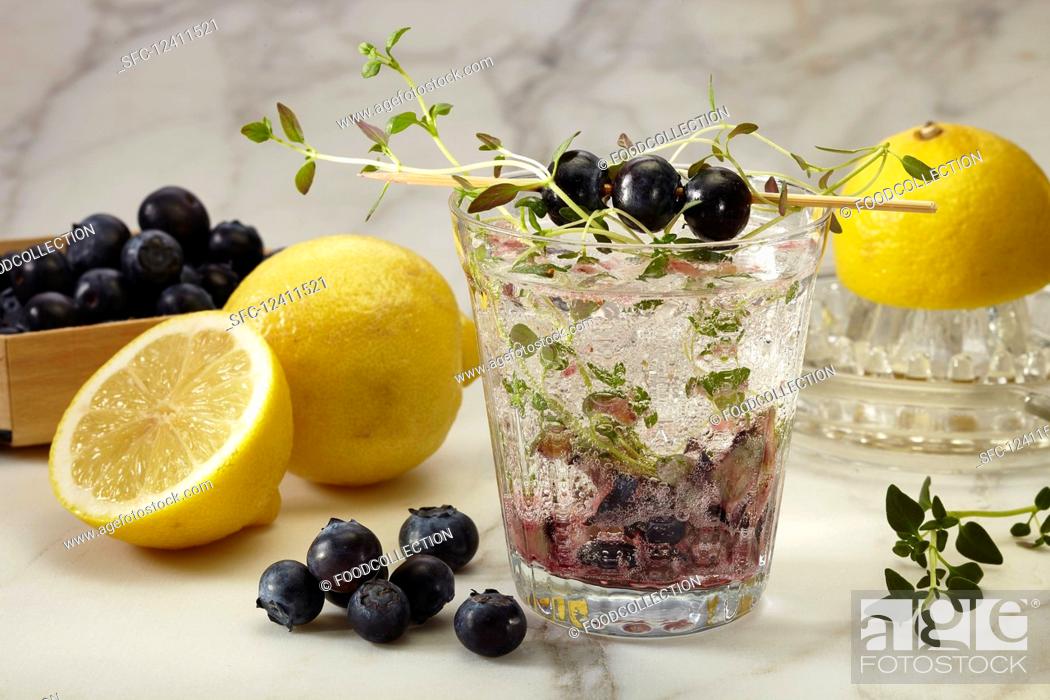 Stock Photo: A glass of blueberry lemonade with thyme.