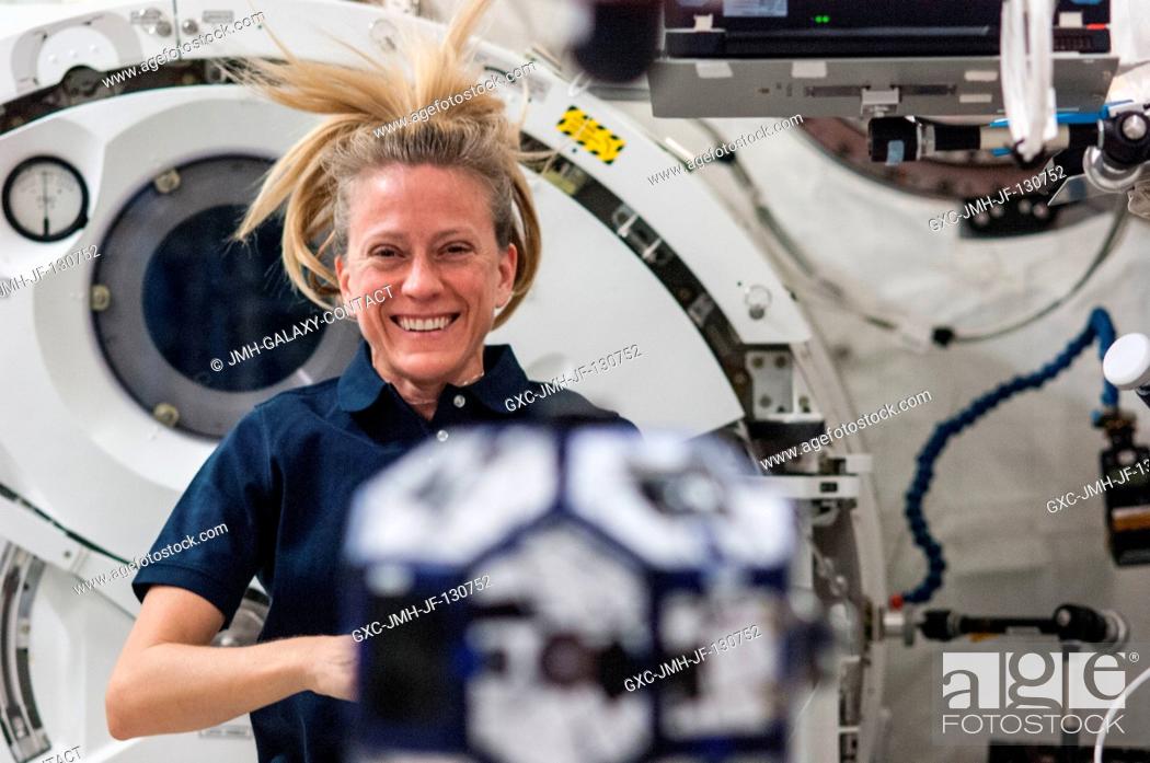 Stock Photo: In the International Space Station's Kibo laboratory, NASA astronaut Karen Nyberg, Expedition 36 flight engineer, conducts a session with a pair of.