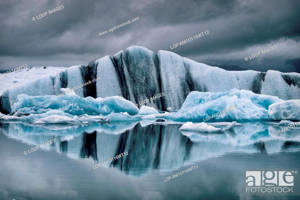 Stock Photo: Icebergs in Jokulsarlon Glacial lagoon under a moody sky.