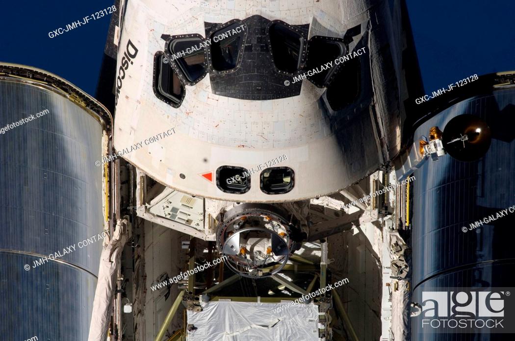 Stock Photo: An overhead close-up view of the exterior of Space Shuttle Discovery's crew cabin, part of its payload bay and docking system was provided by Expedition 18.