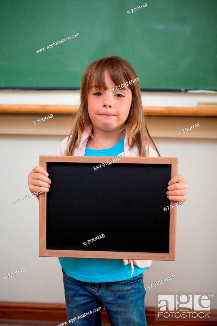 Stock Photo: Portrait of a little girl holding a school slate.