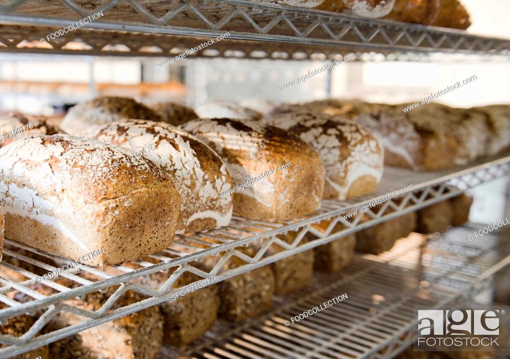 Stock Photo: Tin loaves on metal shelves after being baked in a coal-fired oven in a small countryside bakery.