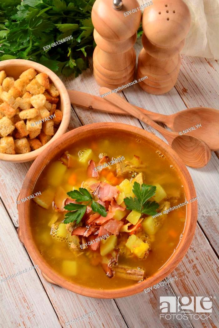 Stock Photo: Lentil pea soup garnish with bacon, fried onion and croutons.