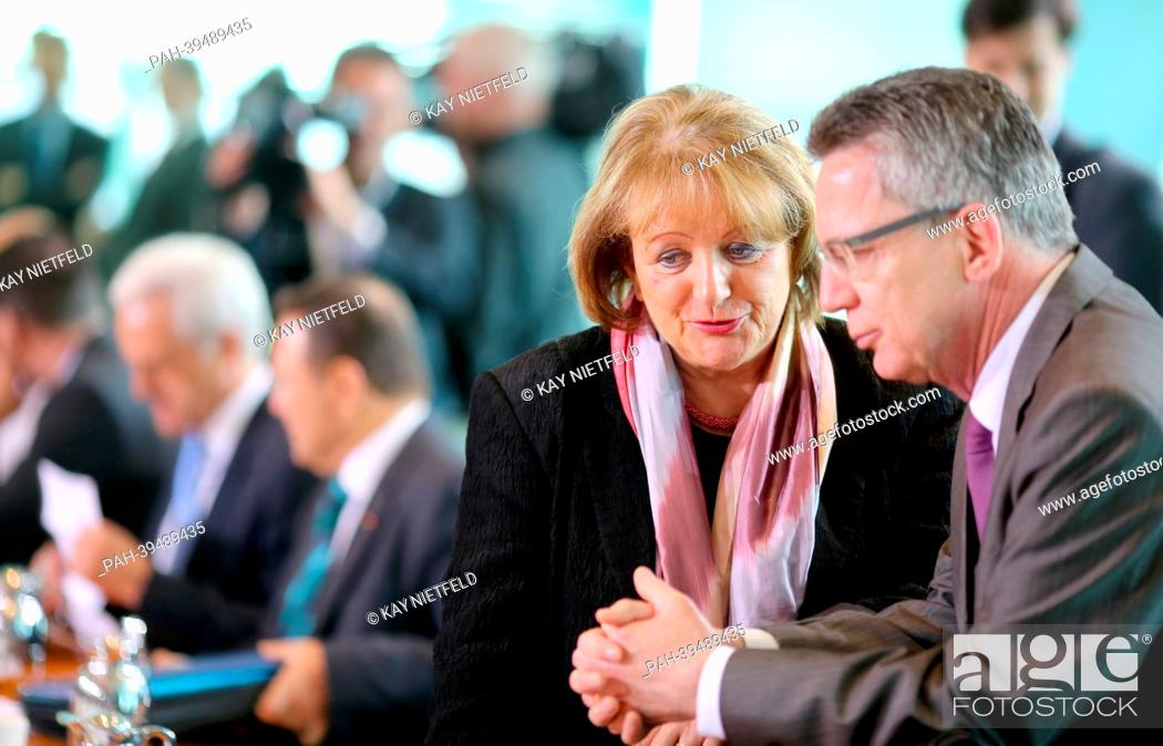 Stock Photo: German Justice Minister Sabine Leutheusser-Schnarrenberger and Defense Minister Thomas de Maiziere chat before the cabinet meeting at the chancellery in Berlin.