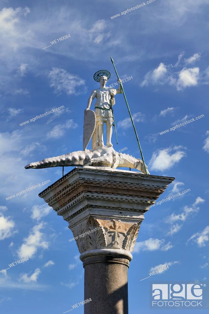 Stock Photo: Venice, Venice Province, Veneto Region, Italy. Statue of St. Theodore atop granite column in the Piazzetta. He has a spear in his hand and his foot rests on a.
