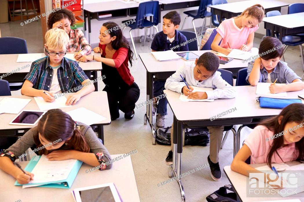 Stock Photo: Elevated view of teacher and kids in elementary school class.