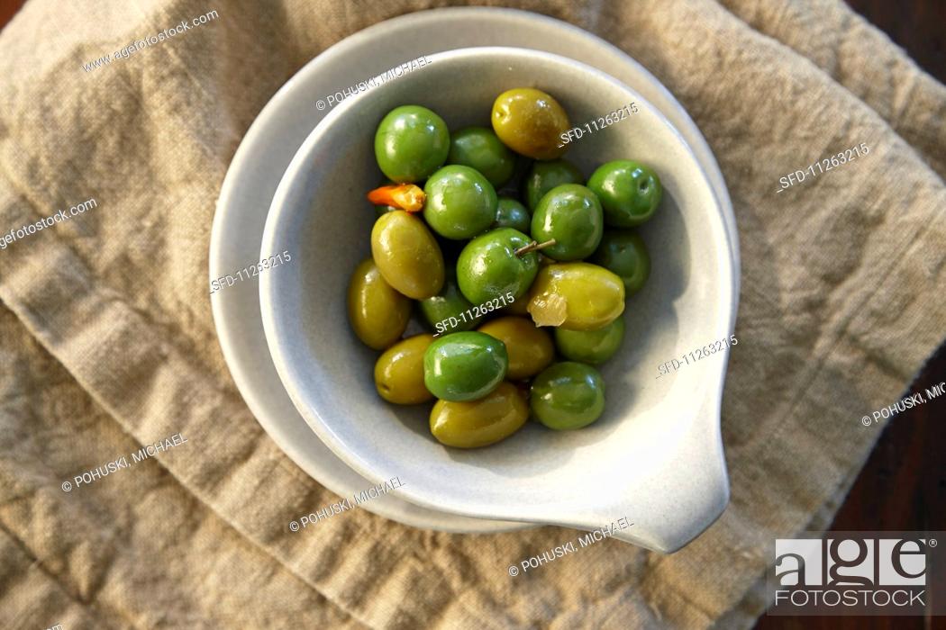 Stock Photo: Green olives and capers in a dish.