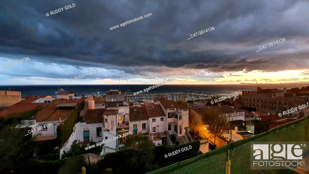 Stock Photo: Stormy clouds at sunset, dramatic sky, coastal landscape, weather scenery El Masnou, Barcelona, Spain.