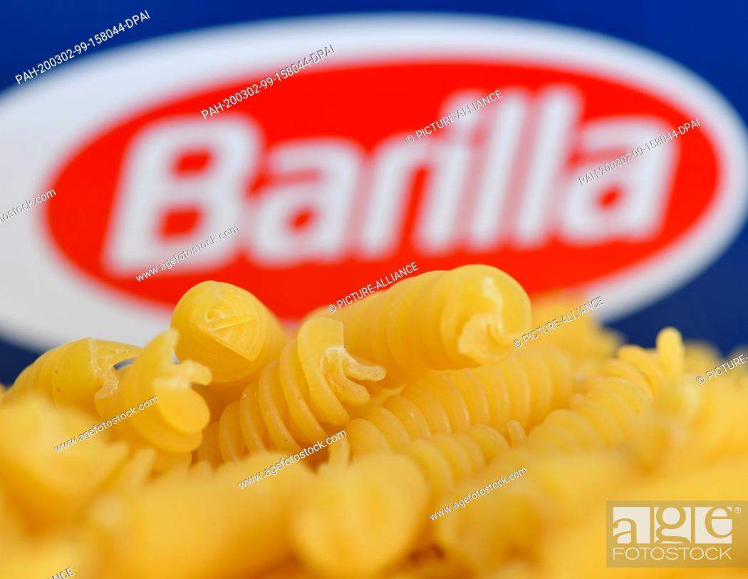 Stock Photo: 02 March 2020, Brandenburg, Grünheide: ILLUSTRATION - Barilla brand pasta is placed on a package (placed intake). While many German citizens are stocking up on.