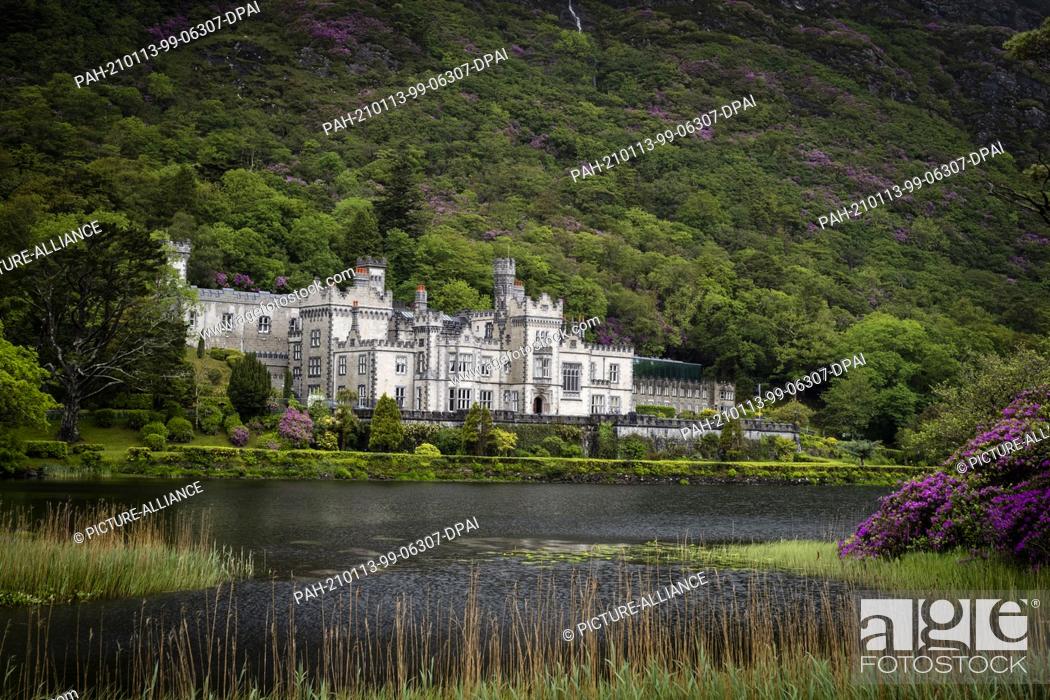 Stock Photo: 29 May 2019, Ireland, Connach: A view of the Kylemore Abbey estate on Pollacapul Lough near Ireland's Connemara National Park.