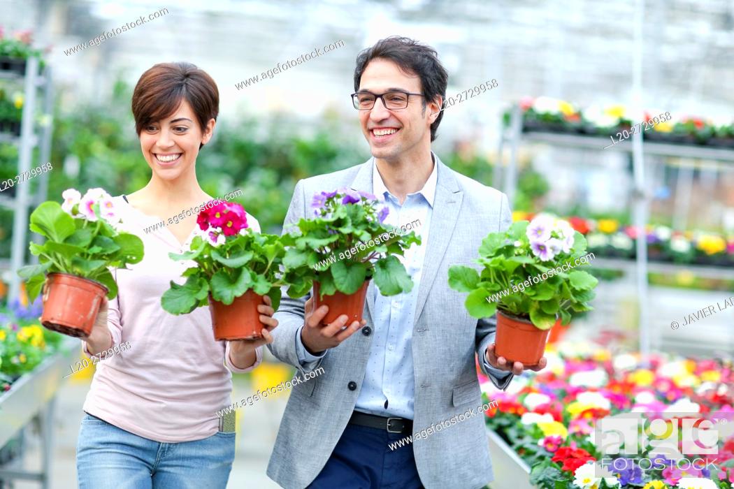 Stock Photo: Couple buying flowers, garden center.