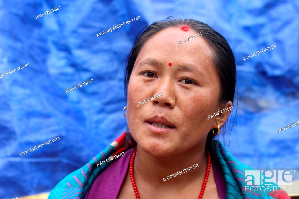 Stock Photo: A Nepalese woman named Makha sits in front of the ruins of her house in Suspa, Nepal, 01 April 2016. Many people in rural regions have no funds for the.