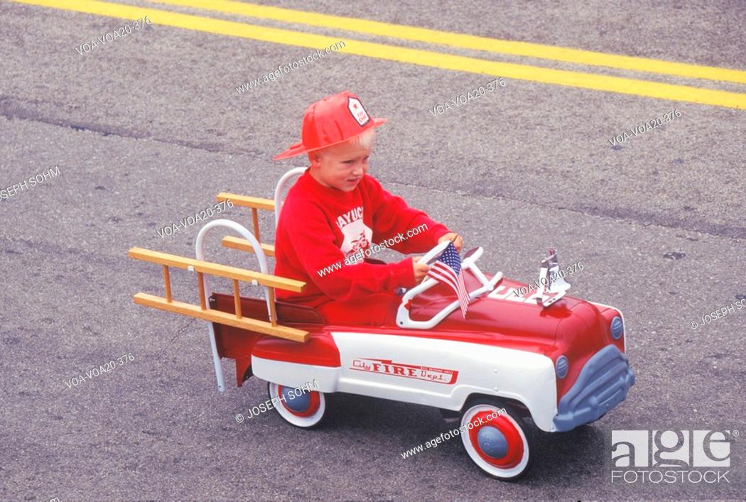 Stock Photo: Boy in Toy Fire truck in July 4th Parade, Cayucos, California.