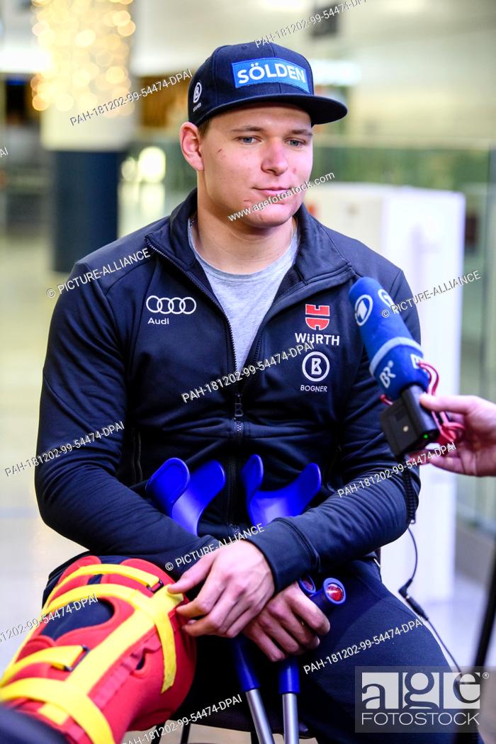 Stock Photo: 02 December 2018, Bavaria, München: Ski racer Thomas Dreßen makes a press statement on his arrival at the airport after his heavy fall on the descent to Beaver.