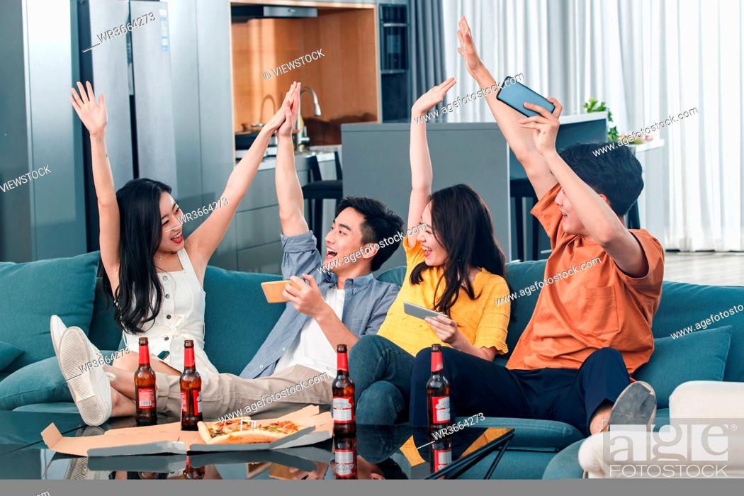 Stock Photo: Exciting young friends celebrate.