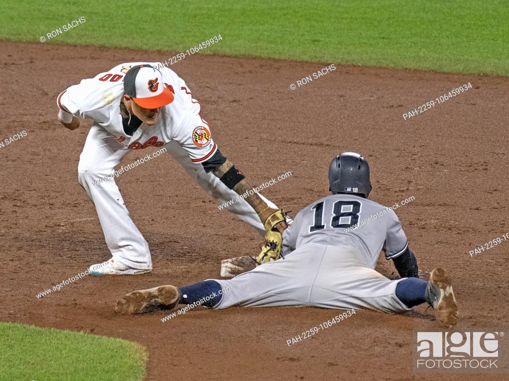 Stock Photo: Baltimore Orioles shortstop Manny Machado (13) tags out New York Yankees shortstop Didi Gregorius (18) in the ninth inning of their game at Oriole Park at.