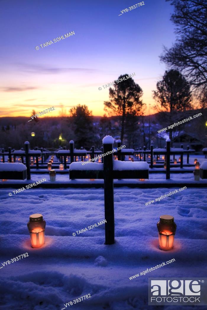 Stock Photo: Crosses and candles on graves of soldiers fallen in Finland's wars early on Christmas morning in Salo, Finland.