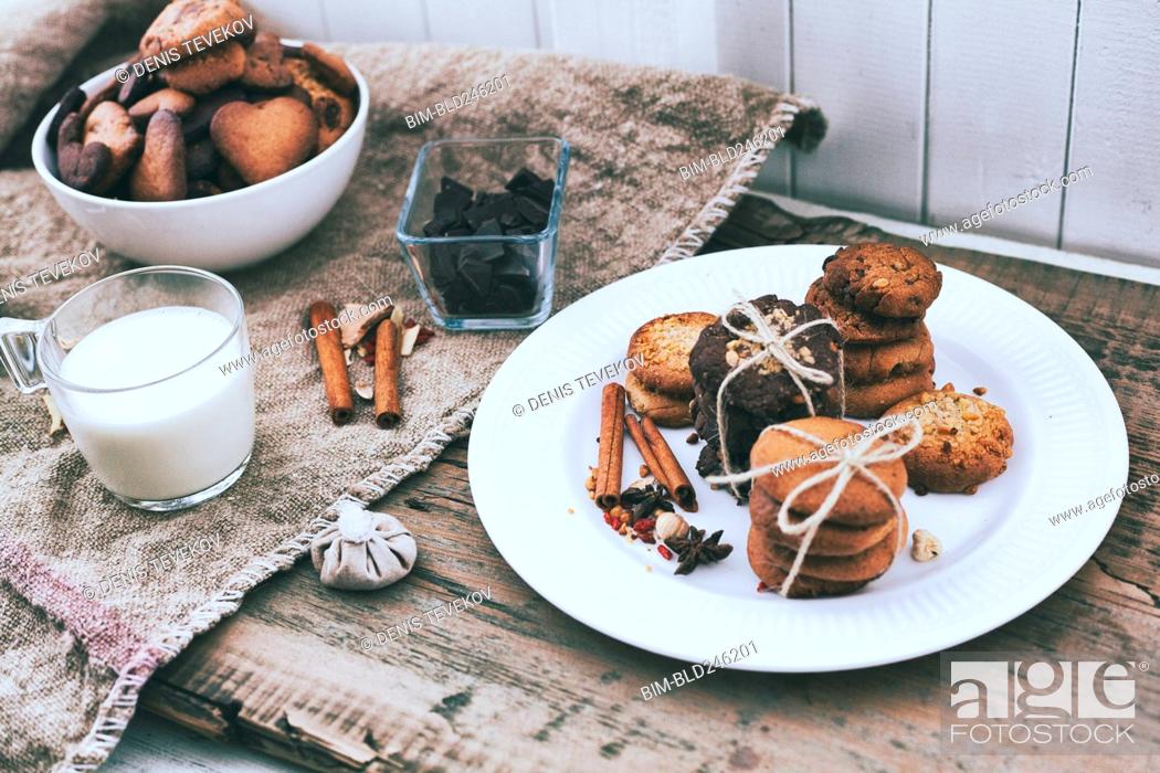 Stock Photo: Bundles of cookies tied with string on plate near ingredients.