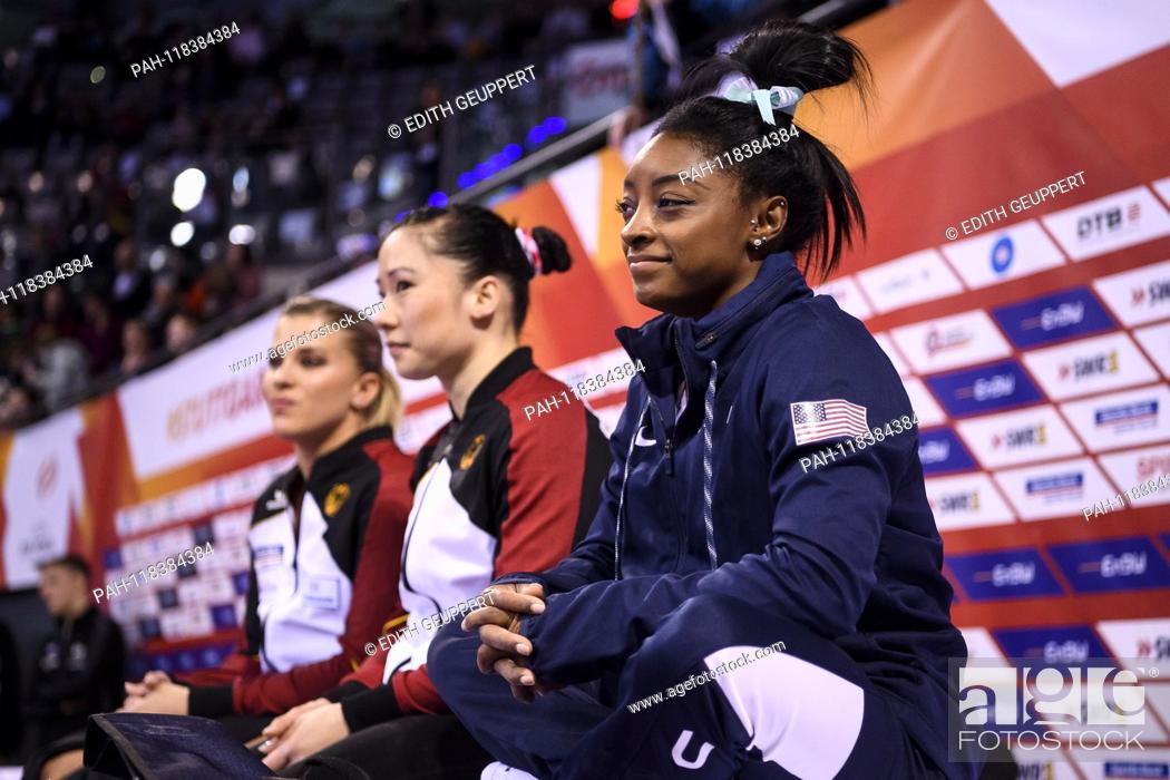 Stock Photo: Simone Biles (USA), in the background Kim Bui (GER) and Elisabeth Seitz (GER) (from right). GES / Gymnastics / EnBW DTB Pokal, World Cup Ladies, 17.03.