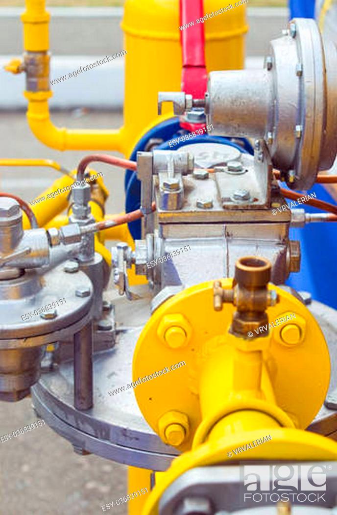 Stock Photo: ellow gas pressure regulator with a crane and gear.