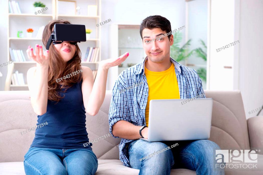 Stock Photo: Young family playing games with virtual reality glasses.