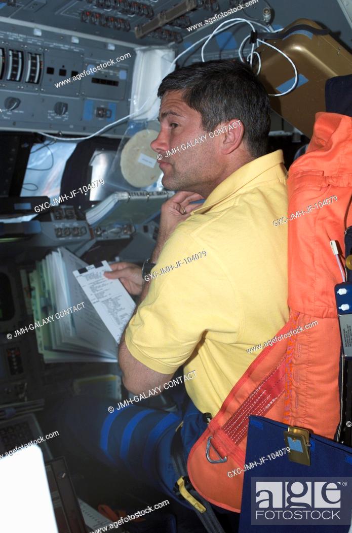 Stock Photo: Astronaut Paul S. Lockhart, STS-111 pilot, consults a check list on the day prior to rendezvous and docking operations between the Space Shuttle Endeavour and.