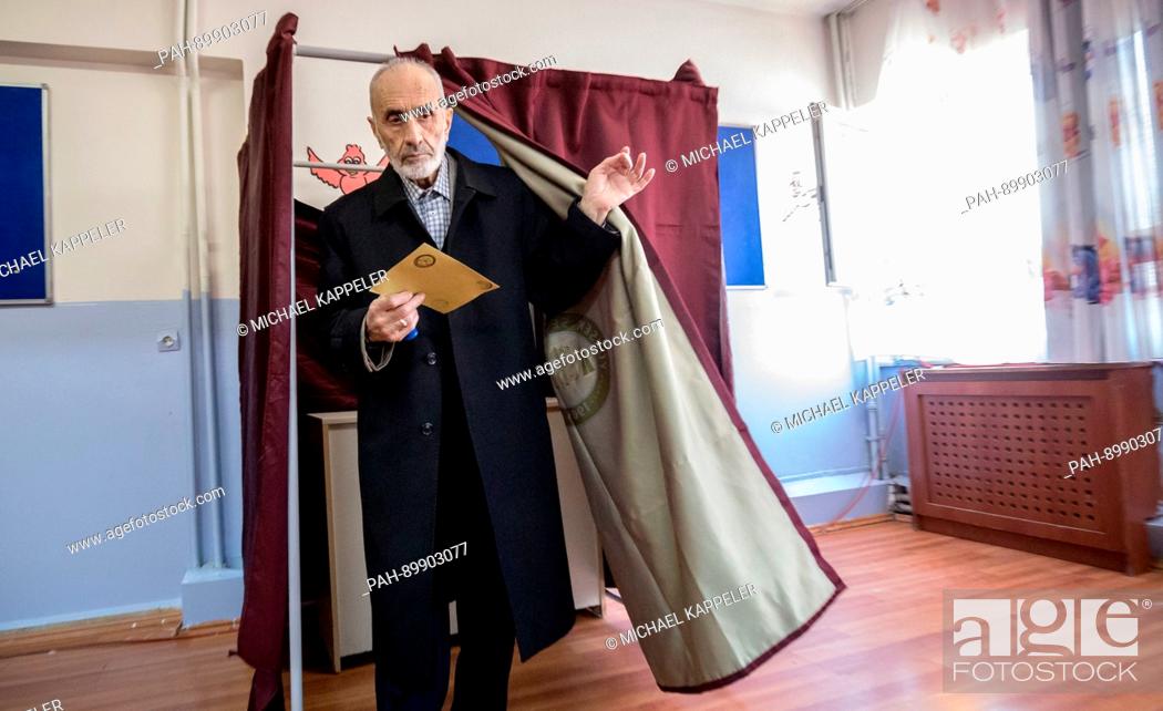 Stock Photo: A man comes out of a polling booth with his ballot at a polling station in Istambul, Turkey, 16 April 2017. Turkish citizens are voting on a constitutional.