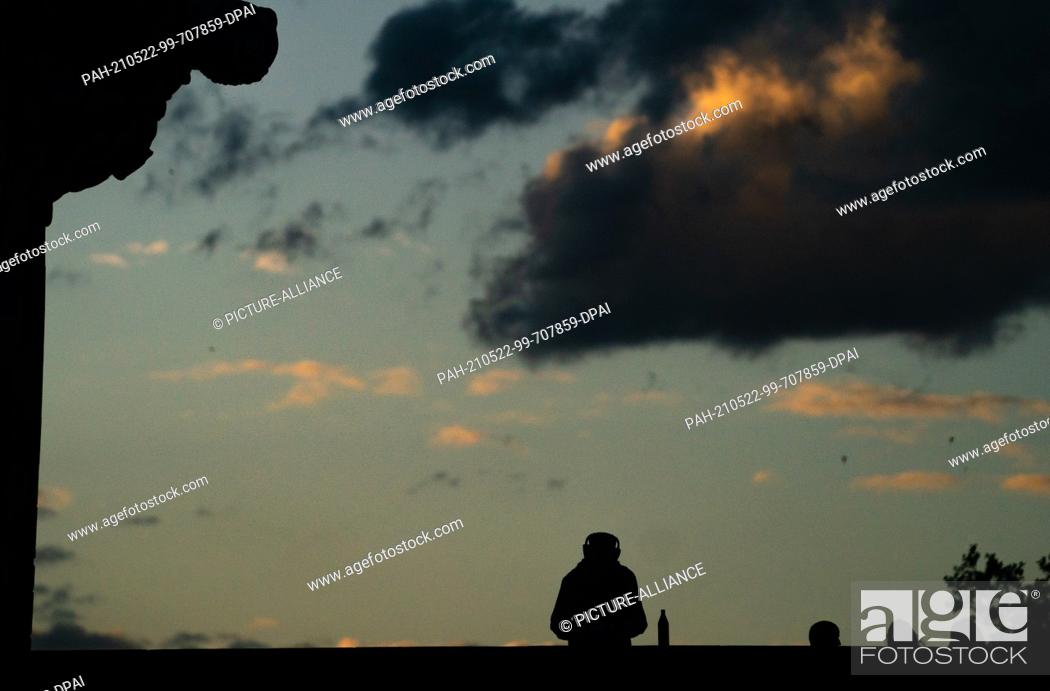 Stock Photo: 22 May 2021, Bavaria, Bamberg: A man stands on the upper bridge by the old town hall at late dusk. Photo: Nicolas Armer/dpa. - Bamberg/Bavaria/Germany.