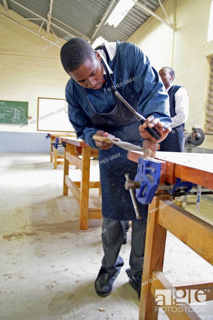 Stock Photo: School boy sawing in woodwork classroom, St Mark's School, Mbabane, Hhohho, Kingdom of Swaziland.