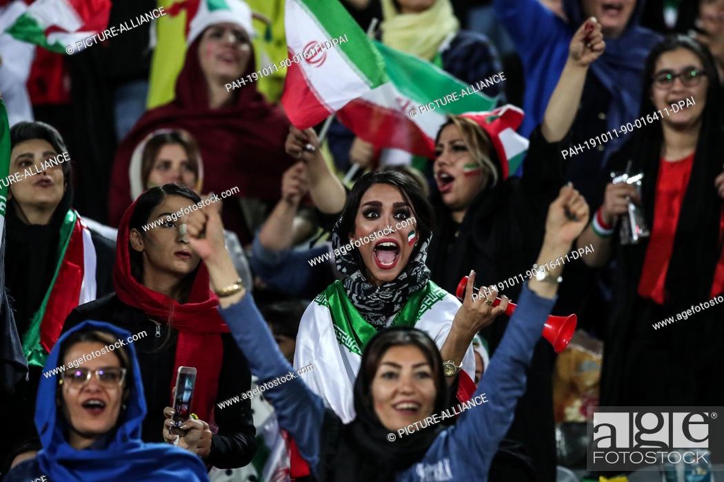 Stock Photo: 10 October 2019, Iran, Tehran: Iranian women attend the FIFA soccer World Cup qualification match between Iran and Cambodia at the Azadi Stadium.