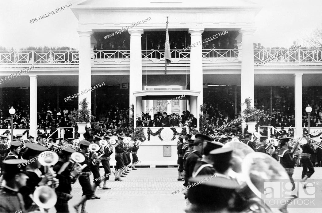 Stock Photo: President Woodrow Wilson and Vice President Marshall watch Inaugural Parade, March 4, 1913. A military band marches past the White House reviewing stand.