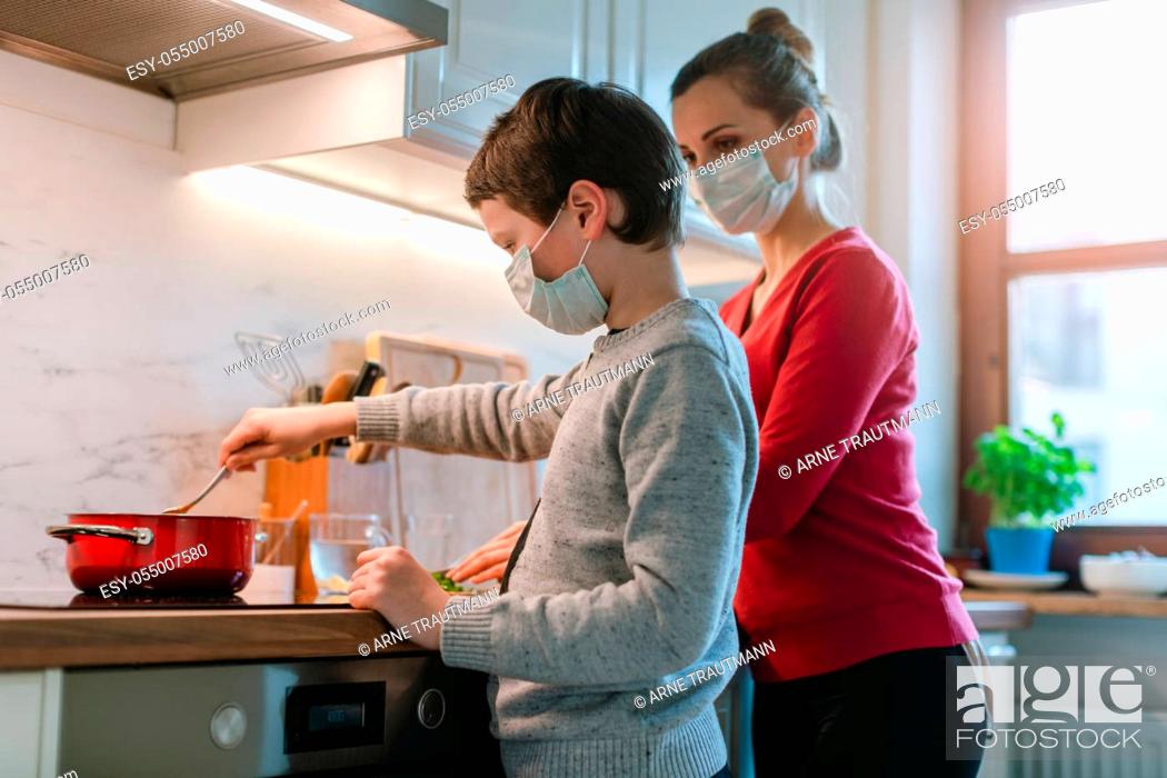Stock Photo: Family cooking at home in kitchen during coronavirus crisis.