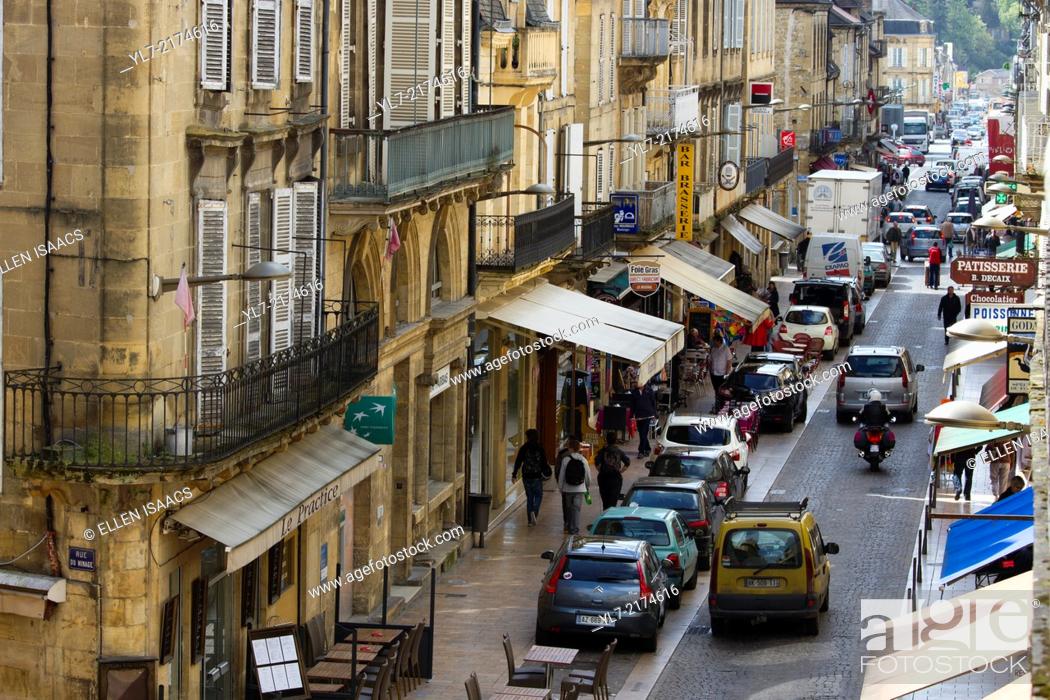 Stock Photo: Busy shops and tourists along Rue de la Republique, the main street in charming Sarlat, in the Dordogne region of France.
