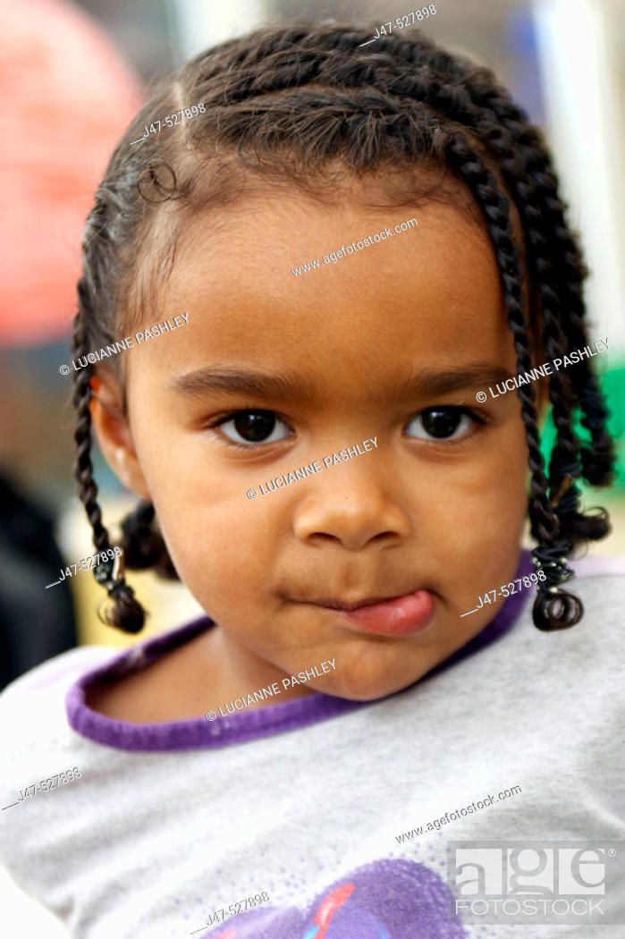 3 year old black girl playing at nursery, pulling a face into camera, with  braids in her hair, Stock Photo, Picture And Rights Managed Image. Pic.  J47-527898 | agefotostock