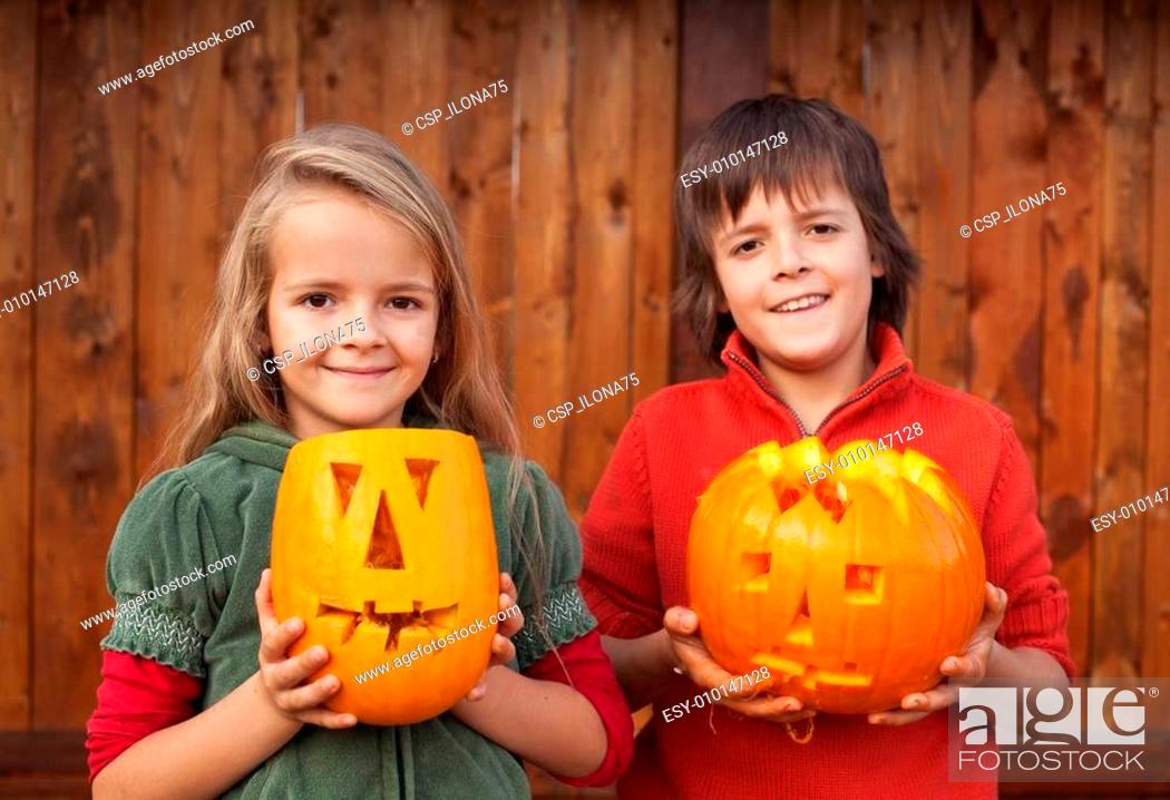 Stock Photo: Kids with Halloween pumpkin jack-o-lanterns.