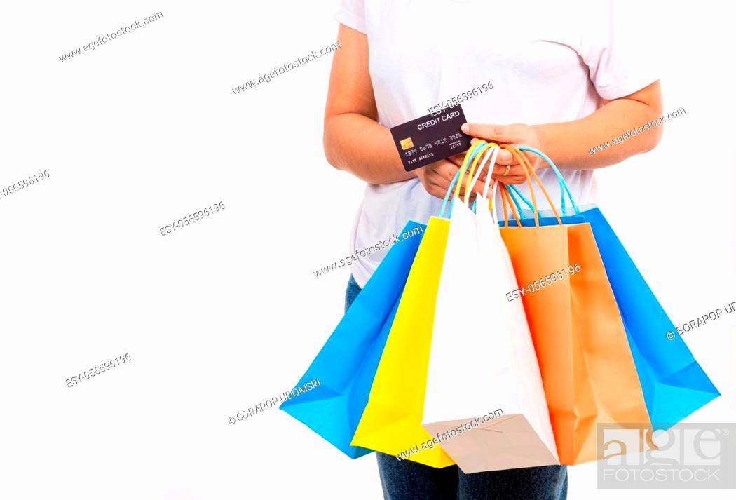 Stock Photo: Happy woman hand holding shopping bags multicolor and credit card for shopping online, young female hold many packets within arms isolated on white background.