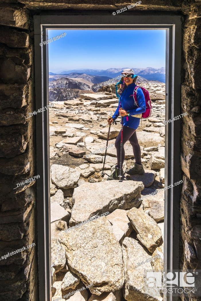 Stock Photo: Hiker from inside the summit hut on Mount Whitney, Sequoia National Park, California USA.