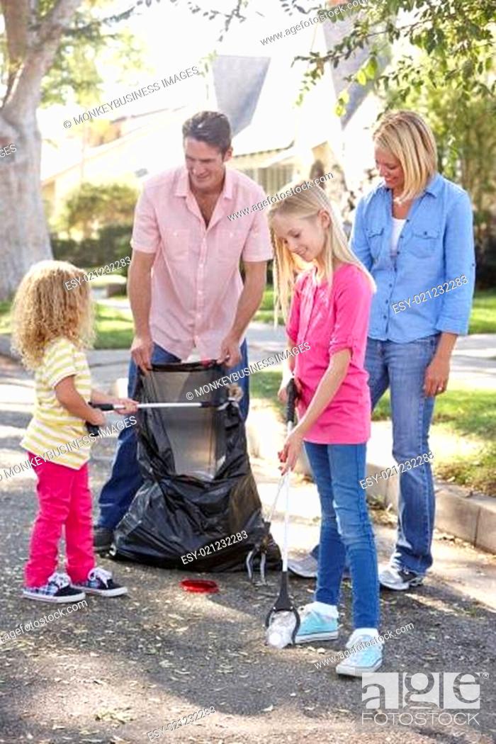 Stock Photo: Family Picking Up Litter In Suburban Street.