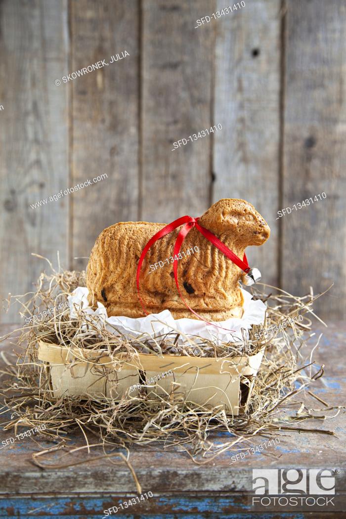 Stock Photo: Lamb shaped yeast dough with raisins for Easter.