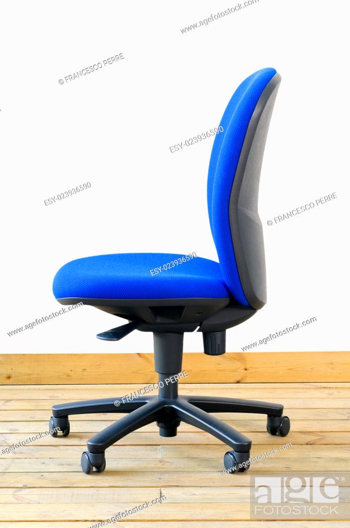 Stock Photo: modern blue office chair on wood floor over white background.