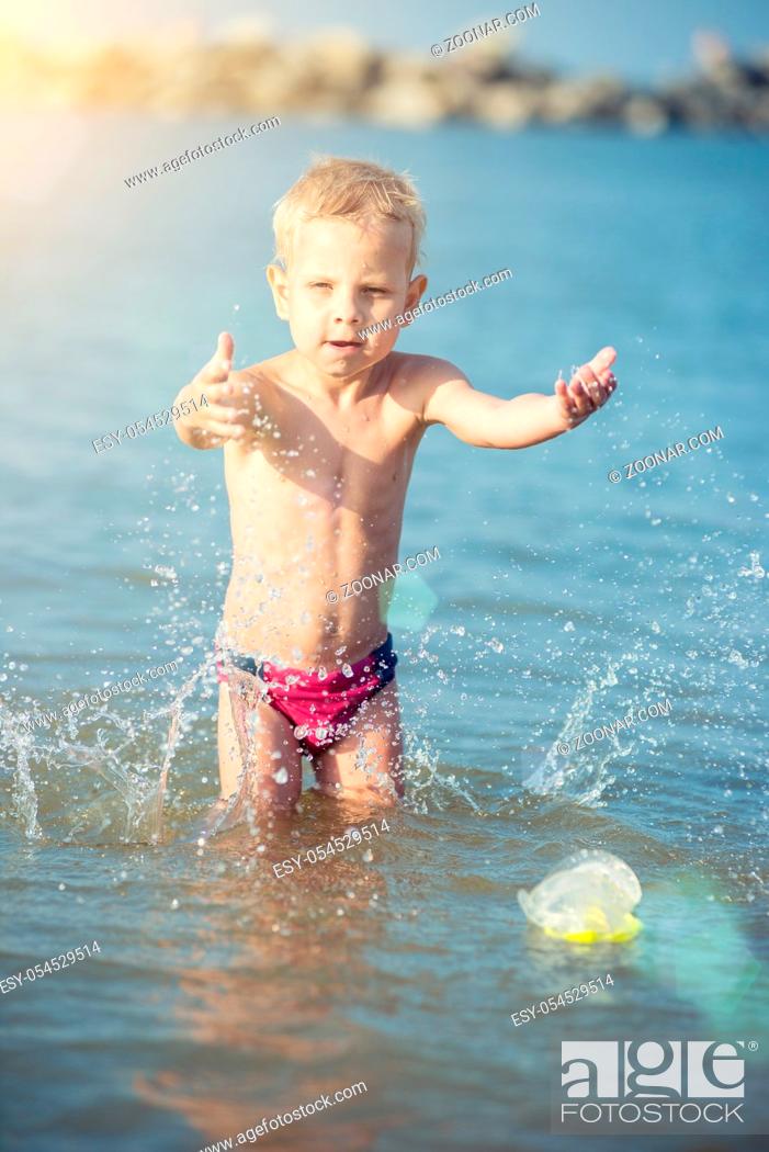Stock Photo: Little boy with snorkel by the sea. Cute little kid wearing mask and flippers for diving at sand tropical beach. Ocean coast.